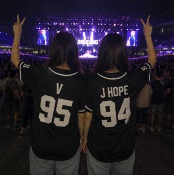 Black BTS baseball jersey back view on model showing custom name